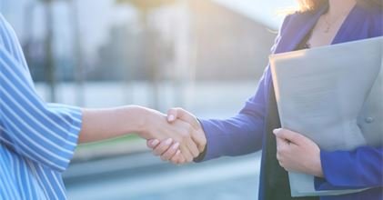 two-busy-businesswomen-have-unformal-meeting-outside-they-are-greeting-one-each-other-with