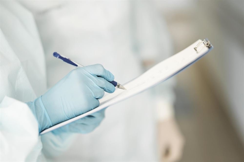 close-up-doctors-completing-medical-form close-up-doctors-completing-medical-form