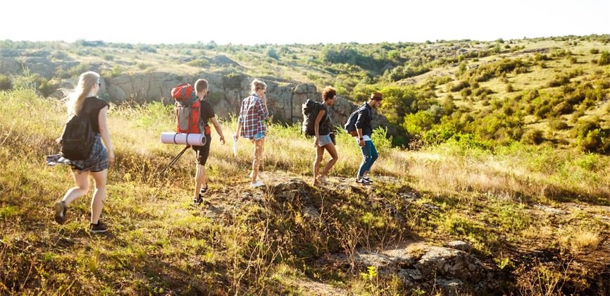 young-beautiful-friends-travelers-with-backpacks-walking-canyon(1)